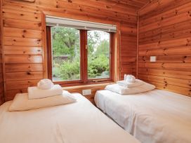 A bedroom with two beds and a window at 89 Ambleside in White Cross Bay