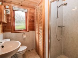 A bathroom with a sink, toilet, and shower at 89 Ambleside White Cross Bay
