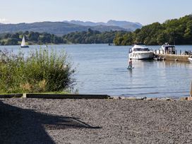 A person paddleboarding near boats at 89 Ambleside in White Cross Bay