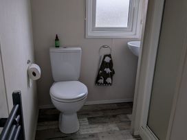 A bathroom with a toilet and sink at Presthaven - Denbigh Dunes in Gronant