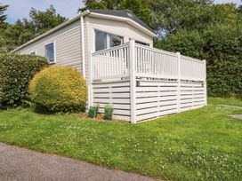 A mobile home with a deck and garden at 5 Silverbow