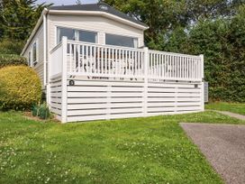 An outdoor view of a caravan with a deck at 5 Silverbow