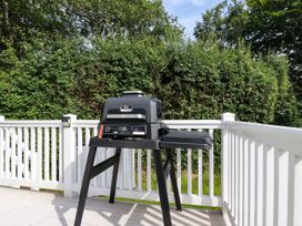 A grill on a deck with greenery in the background at 5 Silverbow