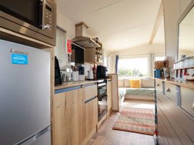A kitchen with appliances and a seating area at 5 Silverbow