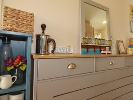 A living room with a drawer unit and decorative items at 5 Silverbow