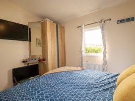 A bedroom with a bed and a wardrobe at 5 Silverbow
