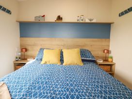 A bedroom with a bed and shelf at 5 Silverbow