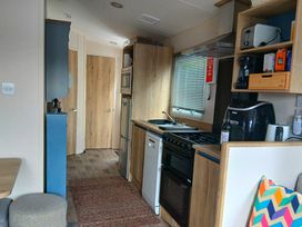 A kitchen with appliances and storage in Porthcurno 5 Perranwell near Goonhavern