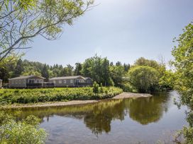 A view of caravans next to a river at Hornshole Hideaway Caravan Hawick Riverside Caravan Park near Hawick