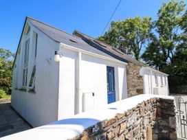 An exterior view of a white house with blue door at Tegfan Newport