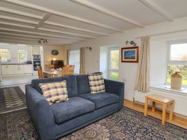 A living room with a sofa and table at Tegfan in Newport