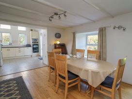 A dining room with a table and chairs at Tegfan in Newport
