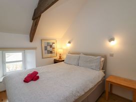 A bedroom with a bed and bedside table at Tegfan in Newport