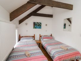 A bedroom with two beds and a table at Tegfan in Newport