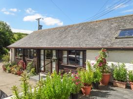 An exterior view of a cottage with planting around the entrance at Pillhead Cart Linhay Bideford