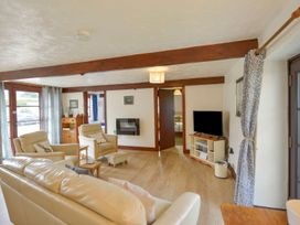 A living room with a television and seating area at Pillhead Cart Linhay in Bideford