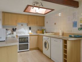 A kitchen with appliances and cabinets at Pillhead Cart Linhay in Bideford