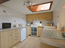A kitchen with appliances and cabinets at Pillhead Cart Linhay in Bideford