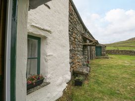 An outdoor area with a window and stone wall at Brigg House in Broughton-in-Furness