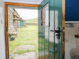 An entrance with an open door and view of the garden at Brigg House in Broughton-in-Furness
