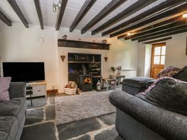 A living room with a fireplace and sofa at Brigg House in Broughton-in-Furness