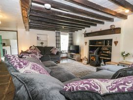 A living room with a television and fireplace at Brigg House Broughton-in-Furness