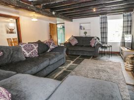 A living room with sofas and a television at Brigg House in Broughton-in-Furness