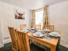 A dining room with a wooden table and chairs at Brigg House Broughton-in-Furness