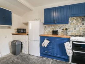 A kitchen with appliances and cabinets at Brigg House in Broughton-in-Furness