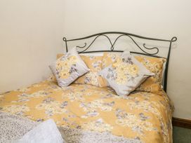 A bed with decorative pillows at Brigg House in Broughton-in-Furness