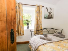 A bedroom with a bed and window at Brigg House in Broughton-in-Furness