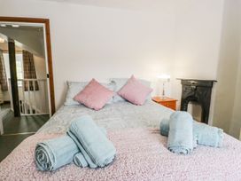 A bedroom with a bed and towels at Brigg House in Broughton-in-Furness