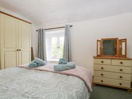 A bedroom with a bed and wardrobe at Brigg House in Broughton-in-Furness