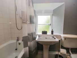 A bathroom with a bathtub, sink, and toilet at Brigg House in Broughton-in-Furness