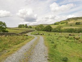 A gravel path with cattle grazing in a field at Brigg House in Broughton-in-Furness