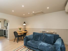A living room with a table and chairs near a kitchen at Foxglove in Stratton Audley near Bicester