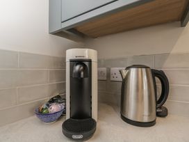 A kitchen with a Nespresso machine and an electric kettle at Foxglove in Stratton Audley near Bicester