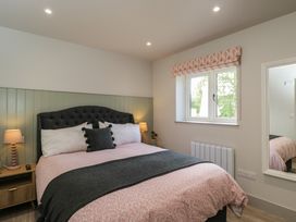 A bedroom with a bed and window at Foxglove in Stratton Audley near Bicester