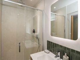 A bathroom with a shower and sink at Foxglove in Stratton Audley near Bicester
