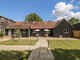 A house with patio furniture and umbrellas at Foxglove in Stratton Audley near Bicester