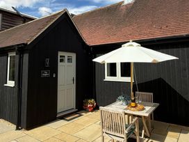 A table with chairs under an umbrella at Foxglove in Stratton Audley near Bicester