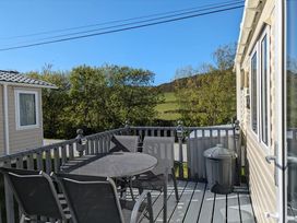 An outdoor area with a table and chairs at Clarach Bay Holiday Village W18 in Aberystwyth