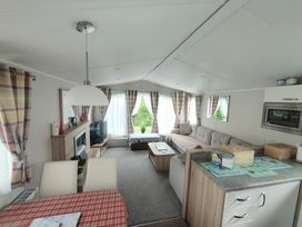A living room with a sofa and television at Clarach Bay Holiday Village W18 Aberystwyth