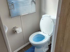 A toilet with a roll of toilet paper at Clarach Bay Holiday Village W18 Aberystwyth
