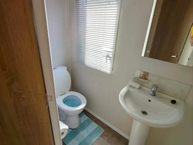 A bathroom with a toilet and sink at Clarach Bay Holiday Village W18 Aberystwyth