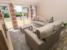A living room with sofas and a coffee table at Sandpiper in Narberth