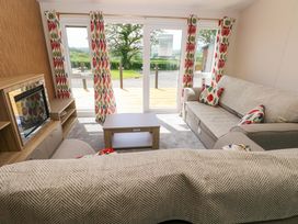 A living room with a sofa and coffee table at Sandpiper in Narberth