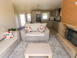 A living room with a sofa and coffee table at Sandpiper in Narberth
