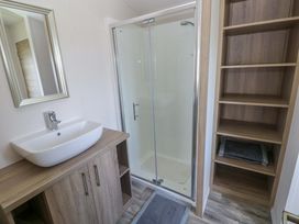 A bathroom with a sink and shower at Sandpiper in Narberth