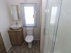 A bathroom with a sink, toilet and shower at Sandpiper in Narberth